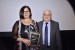 Dr. Nagib Callaos, General Chair, giving Dr. Penelopia Iancu a plaque "In Appreciation for Delivering a Great Keynote Address at a Plenary Session."